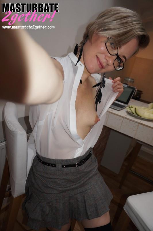 Kelly in her old schoolgirl uniform. A grey pleated skirt that barely covers her ass and pussy, a white blouse that her small boob and nipple peak out from and black knee high socks. She doesn't bother wearing any panties.